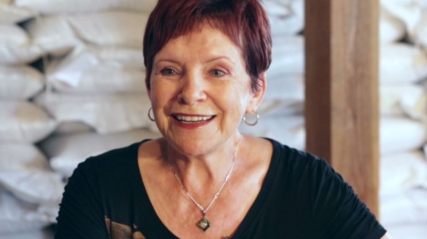 Bust shot of Lise Tremblay with short red hair and earrings, smiling at the camera.