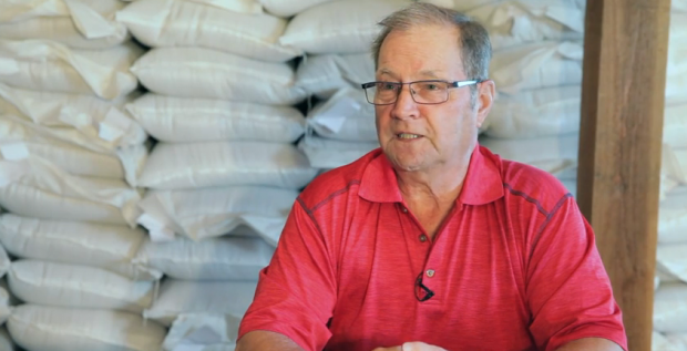 Bust shot of Léon Tremblay with short hair and rectangular glasses, wearing a red polo shirt.