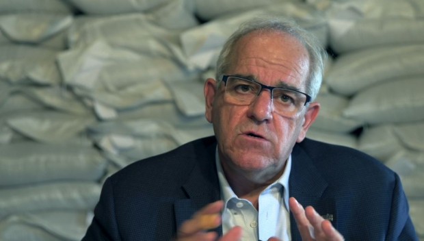 Bust shot of Michel Goyer with white hair and glasses, wearing a dark blue jacket.