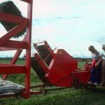 Farmers Overlooking the Mechanical Production of Hay Bales in Guyenne, Abitibi