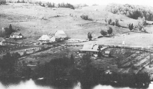 Old aerial photo of the Lac Paquin region showing several houses and a noticeable absence of trees.