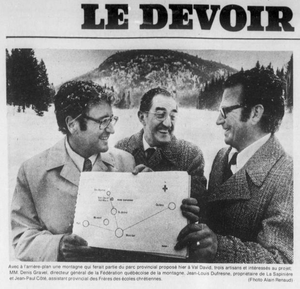 Extract from Le Devoir newspaper showing three men holding onto a plan of the projected Val-David Park.