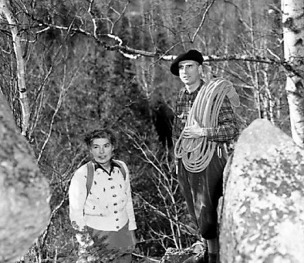 John Brett and his wife in the forest in 1947; John is wearing a beret and holding a climbing rope.