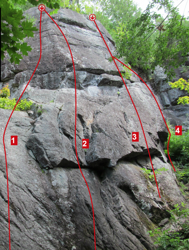 Colour photo of a rock face on which have been drawn four red lines indicating four different climbing routes.