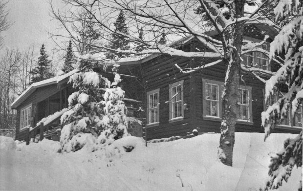 Winter scene from the 1950s showing Auberge Le Rouet, which was a small log-cabin style chalet at the time.