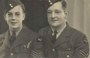 Black and white photograph of two soldiers, father and son, standing, wearing the uniform of the Royal Canadian Air Force. Photograph framing their head and shoulders.