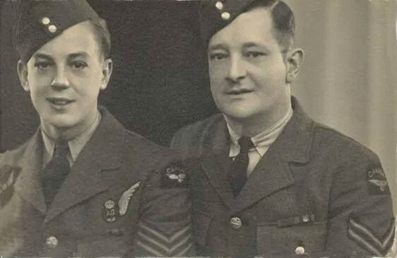 Black and white photograph of two soldiers, father and son, standing, wearing the uniform of the Royal Canadian Air Force. Photograph framing their head and shoulders.