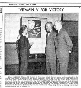Newspaper article titled “Vitamin V for Victory” with a photograph of two adults and a teenager talking in front of a poster advertising war stamps, followed by an eight-line explanatory text.