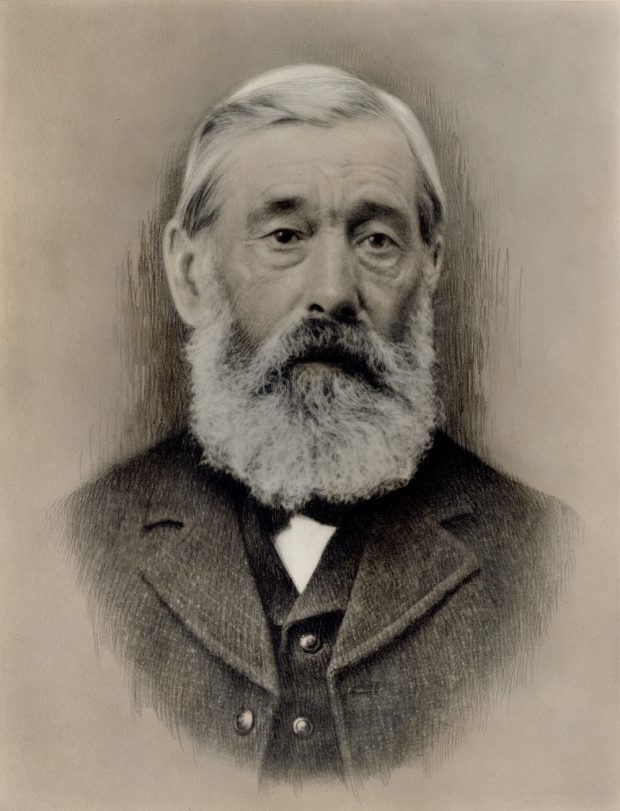 A portrait photograph of an older man, detailed with charcoal accents.