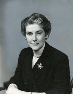 A black and white portrait of an older woman, dressed in a blazer.