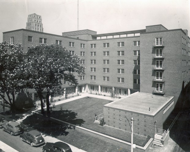 A exterior view of the building from high up, showing the street and cars below.