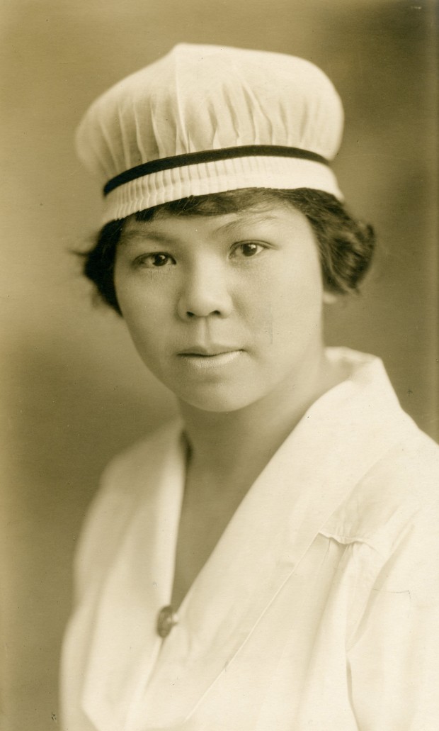 Formal portrait of young lady in full nurses' uniform.