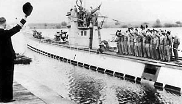 photo of German U-boat and crew waving on deck, departing from port