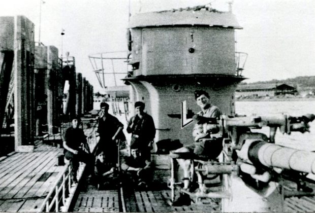 informal photo of German submarine and crew moored at a wharf