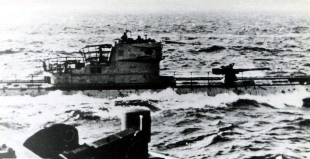 photo of German submarine at sea, showing conning tower and deck gun