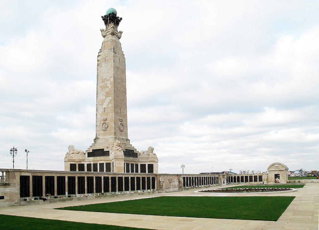 large stone obelisk and stone wall with bronze plaques listing the names of dead Royal Navy sailors