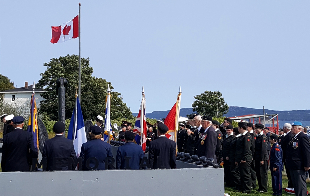 a crowd of uniformed men and women at a remembrance ceremony