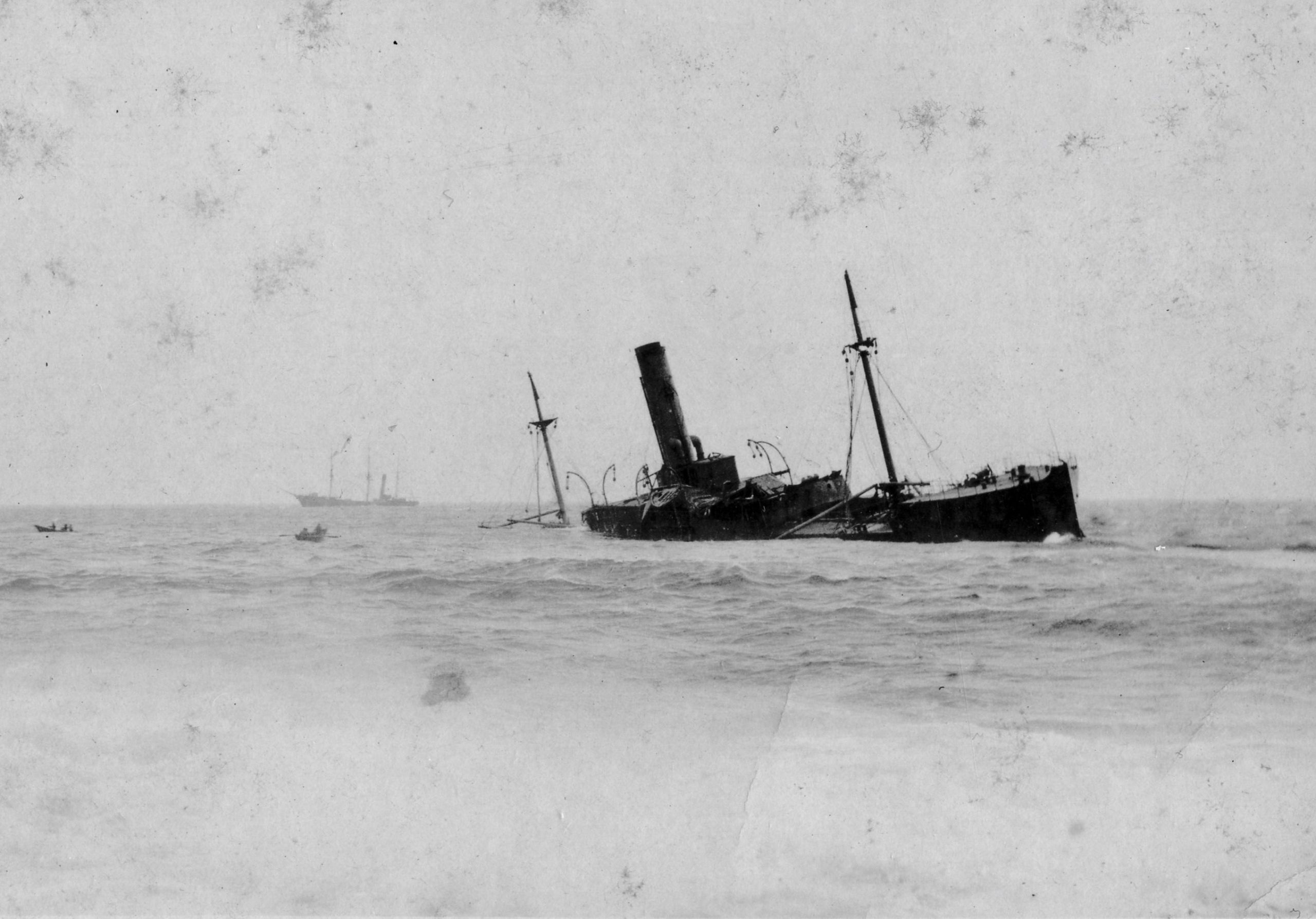 Black and white archival photograph of large passenger liner ship, the SS Florizel, run aground in ocean.