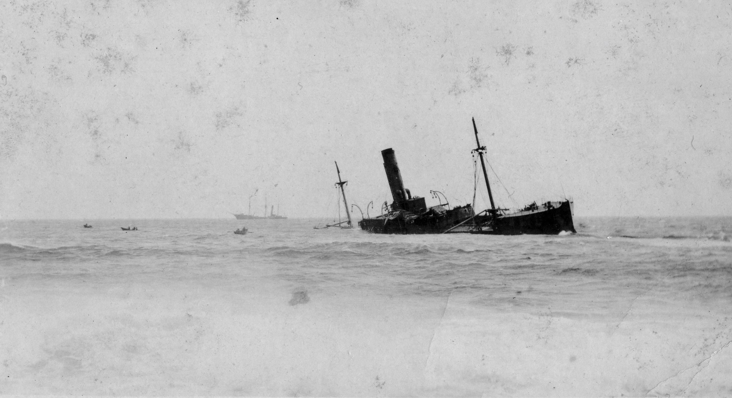 Black and white archival photograph of large passenger liner ship, the SS Florizel, run aground in ocean.